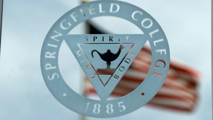 Springfield College seal with American flag in the background