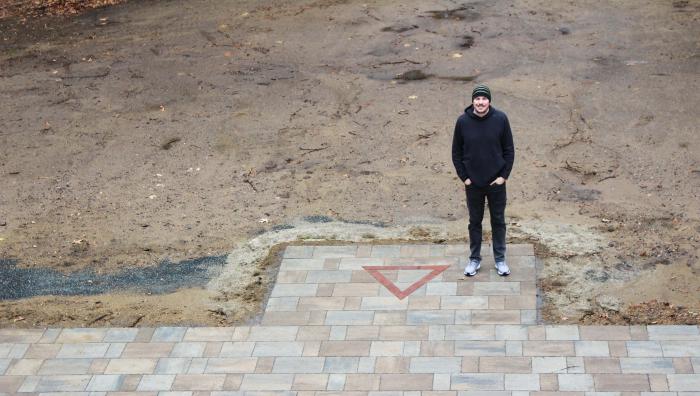 Brian Miles, G’12 stands next to the newly completed patio on East Campus